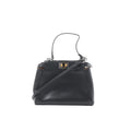 Black Fendi Peekaboo Mini leather handbag with top handle, detachable shoulder strap, and gold-tone twist-lock hardware, front view on a white background.
