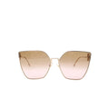 Front view of oversized cat-eye sunglasses with gold-tone metal frame and gradient brown-to-pink lenses on a white background.