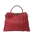 Front view of Fendi Peekaboo Large Selleria handbag in red leather with top handle, shoulder strap, silver-tone turn-lock closure, and soft structured silhouette.