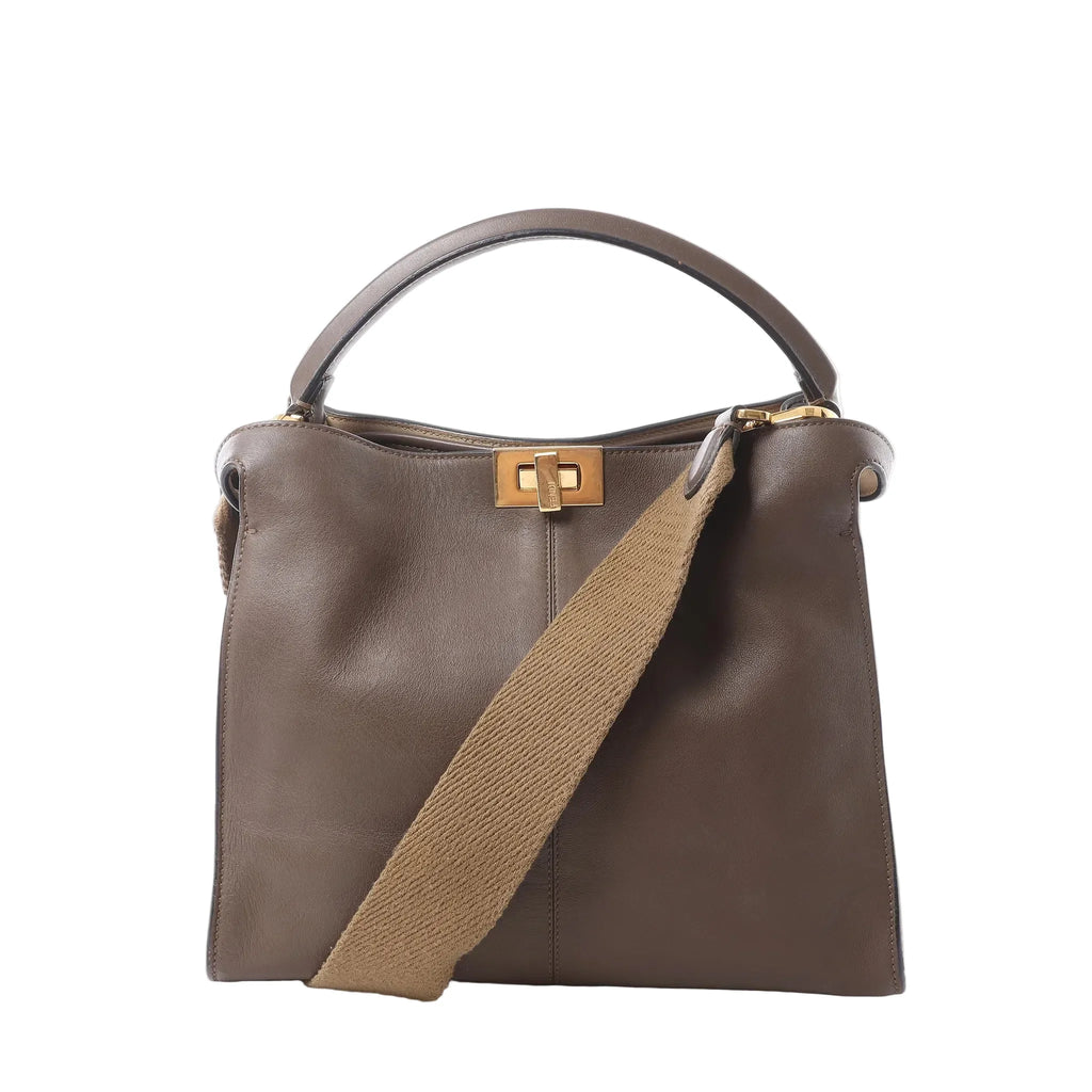 Fendi Peekaboo X-Lite handbag in smooth brown leather with a top handle, wide beige detachable shoulder strap, gold-tone turn-lock closure and structured silhouette on a white background.
