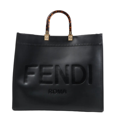 Fendi Sunshine Large Leather Handbag 8BH372 in black with embossed FENDI ROMA logo on the front, structured silhouette, and tortoiseshell-effect top handles with gold-tone Fendi logo hardware, displayed upright against a white background.