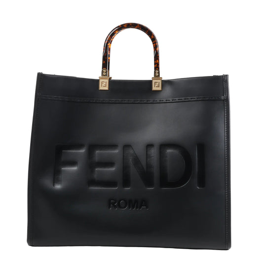 Fendi Sunshine Large Leather Handbag 8BH372 in black with embossed FENDI ROMA logo on the front, structured silhouette, and tortoiseshell-effect top handles with gold-tone Fendi logo hardware, displayed upright against a white background.
