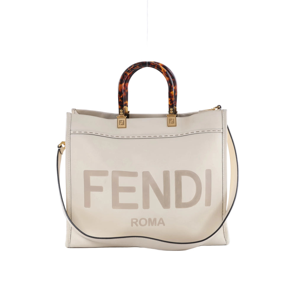 Fendi Sunshine Medium white leather tote bag with tortoiseshell-effect top handles, gold-tone hardware, FENDI ROMA logo and shoulder strap.