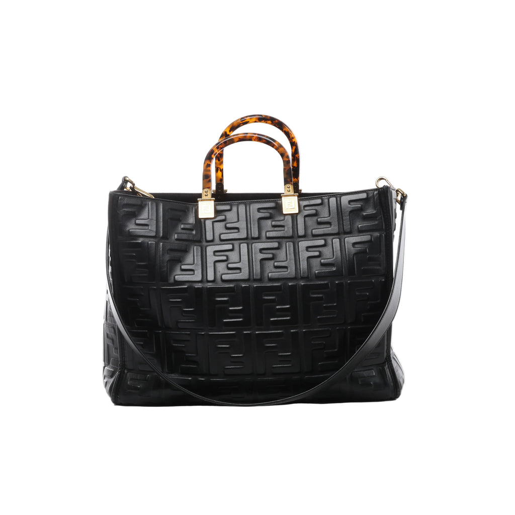 Front view of Fendi Sunshine Medium black leather tote with a raised FF pattern, tortoiseshell-effect top handles, gold-tone fittings and shoulder strap.