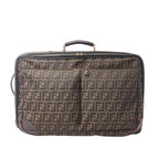 Fendi Zucca travel bag in brown FF monogram canvas with dark brown leather trim, dual front zip pockets, top handle and zip-around closure.