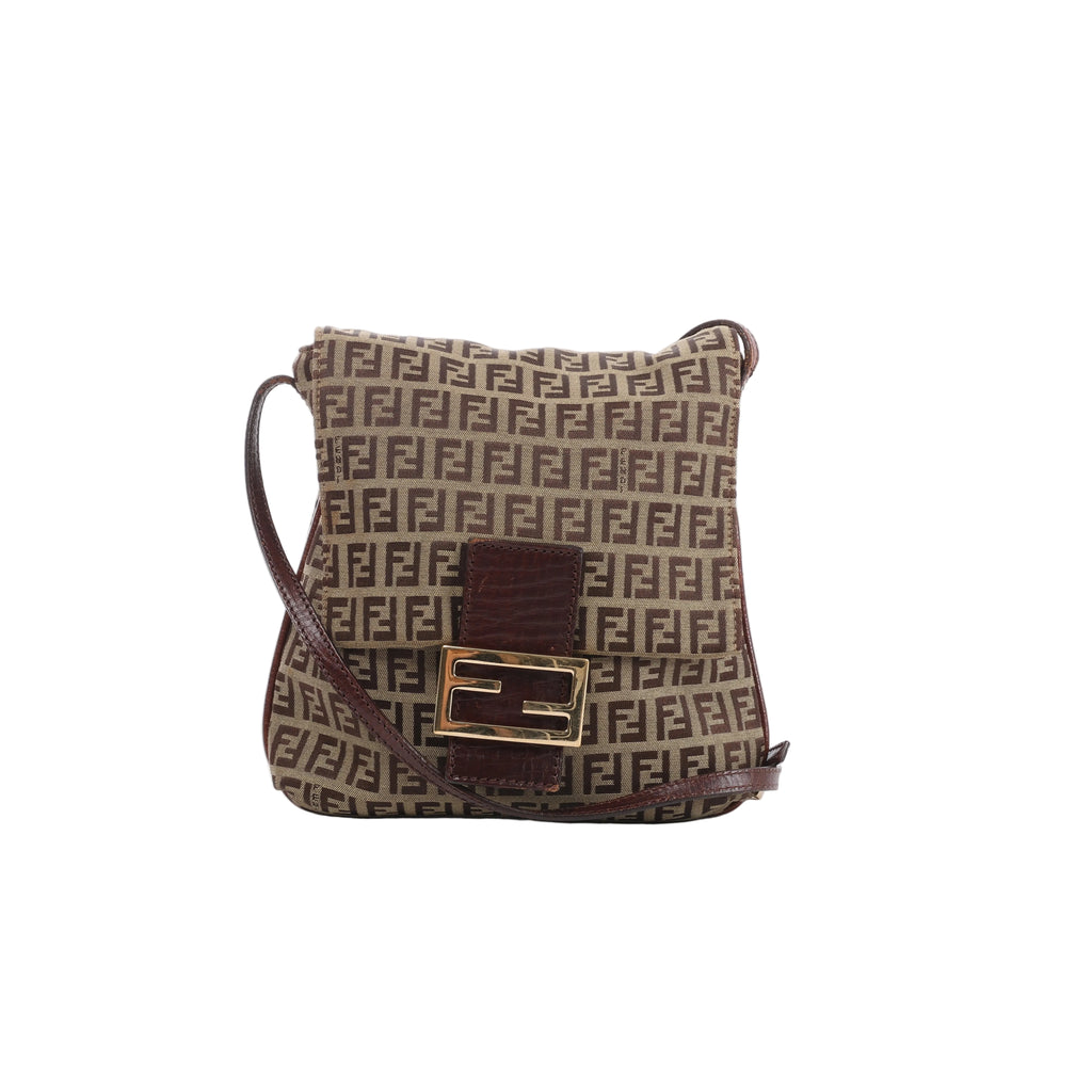 A brown Fendi Zucchino canvas crossbody bag with small FF monogram pattern, brown leather trim, long shoulder strap, and gold-tone FF logo buckle.