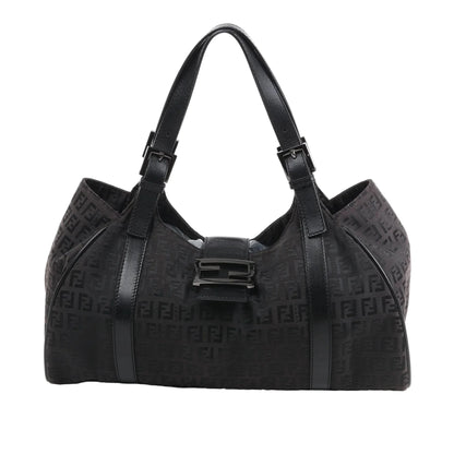 Front view of the FENDI Zucchino Canvas x Leather Handbag 8BR091 in brown, showcasing allover FF monogram canvas, black leather trim and shoulder straps with buckle accents, and a flap closure with black enamel FF buckle, displayed against a white background.