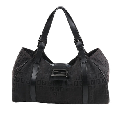 Front view of the FENDI Zucchino Canvas x Leather Handbag 8BR091 in brown, showcasing allover FF monogram canvas, black leather trim and shoulder straps with buckle accents, and a flap closure with black enamel FF buckle, displayed against a white background.