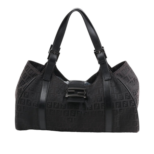 Front view of the FENDI Zucchino Canvas x Leather Handbag 8BR091 in brown, showcasing allover FF monogram canvas, black leather trim and shoulder straps with buckle accents, and a flap closure with black enamel FF buckle, displayed against a white background.