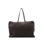 Brown Fendi Zucchino logo canvas tote handbag with repeating FF pattern, black leather shoulder straps, and top zipper closure, shown on a white background.