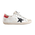 Golden Goose Super-Star Leather Sneakers in white with black glitter star patch, red heel tab, grey laces, and intentionally distressed detailing on the sole and upper, Size 40 EU, displayed in a side profile against a white background.