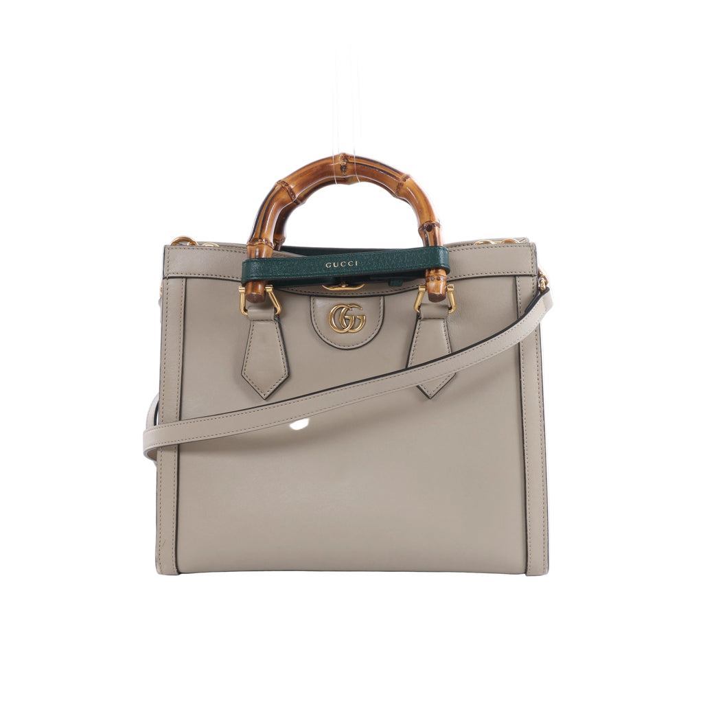Beige Gucci Bamboo Diana leather handbag with bamboo top handles, green and red handle bands, gold-tone hardware and a detachable shoulder strap.