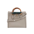 Beige Gucci Bamboo Diana leather handbag with bamboo top handles, green and red handle bands, gold-tone hardware and a detachable shoulder strap.