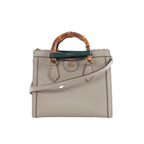 Beige Gucci Bamboo Diana leather handbag with bamboo top handles, green and red handle bands, gold-tone hardware and a detachable shoulder strap.