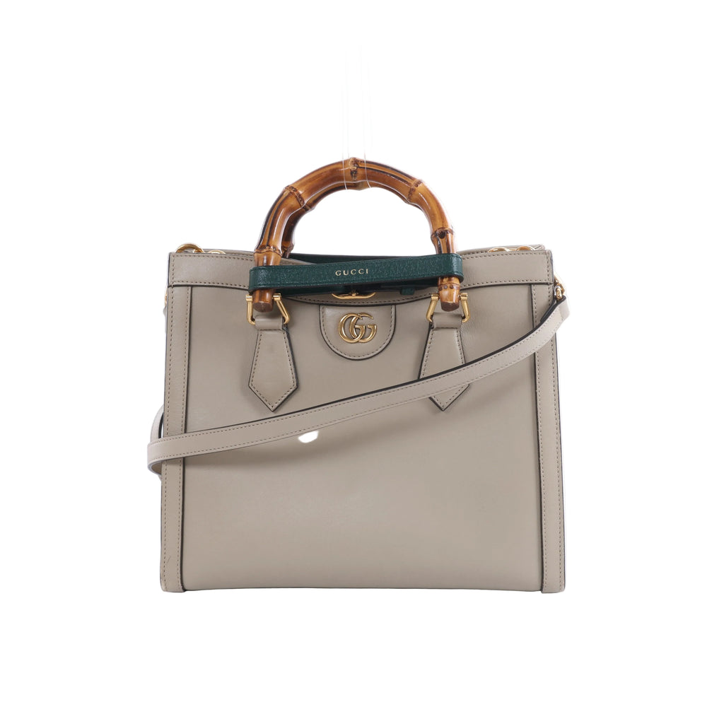 Beige Gucci Bamboo Diana leather handbag with bamboo top handles, green and red handle bands, gold-tone hardware and a detachable shoulder strap.