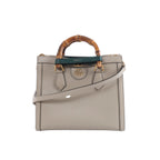 Beige Gucci Bamboo Diana leather handbag with bamboo top handles, green and red handle bands, gold-tone hardware and a detachable shoulder strap.