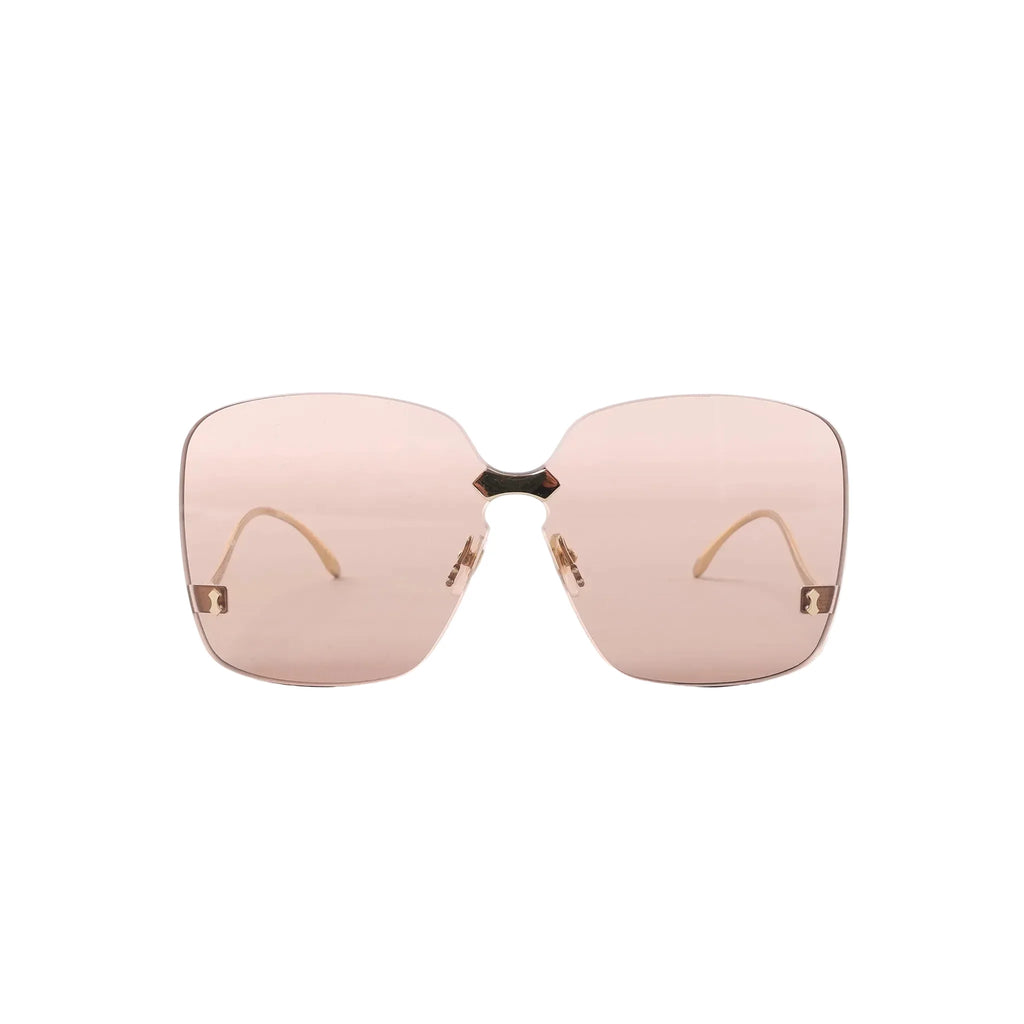 Gucci GG0352S 002 rimless oversized sunglasses with light brown tinted lenses, gold-tone bridge, and small gold corner details on a white background.