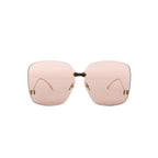 Gucci GG0352S 002 rimless oversized sunglasses with light brown tinted lenses, gold-tone bridge, and small gold corner details on a white background.