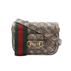 Beige Gucci x Balenciaga monogram crossbody bag with BALENCIAGA print, gold-tone Horsebit hardware and green-red striped shoulder strap.