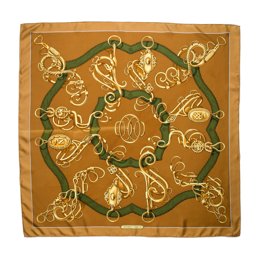 Hermès silk Carré 90 scarf in brown with gold equestrian hardware motif and dark green rope design, with a thin white border.