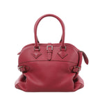 Front view of a rose-pink Hermès Atlas handbag with grained leather, twin rolled handles, a central buckle strap and silver-tone side buckles.