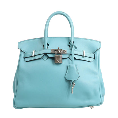 Hermès Birkin 25 Le Tournay handbag in Blue Saint-Cyr Veau Swift leather, featuring dual top handles, palladium hardware, front flap with belted closure, signature padlock and key clochette, and protective metal feet.