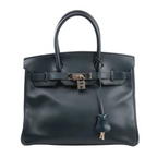 Hermès Birkin 30 handbag in navy blue Veau Epsom leather with dual rolled handles, palladium-tone hardware, front flap, lock and key clochette, and signature belted closure.