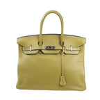 Front view of a Hermès Birkin 35 handbag in Anise Green Taurillon Clemence leather, featuring dual rolled handles, palladium hardware, and a signature flap with turn-lock closure.