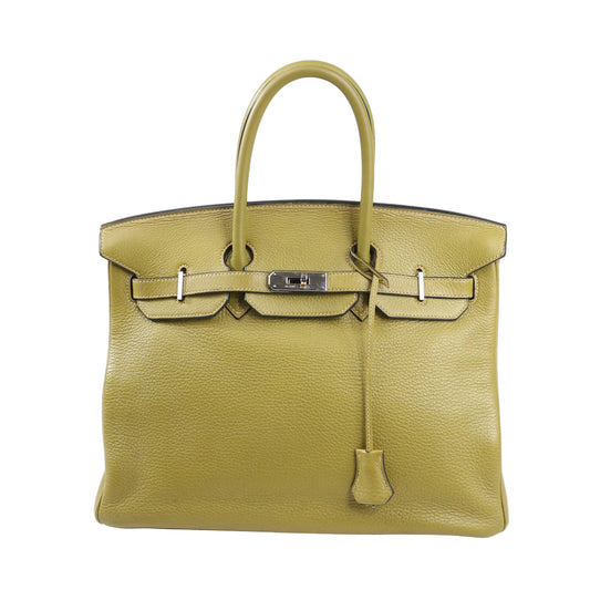 Front view of a Hermès Birkin 35 handbag in Anise Green Taurillon Clemence leather, featuring dual rolled handles, palladium hardware, and a signature flap with turn-lock closure.