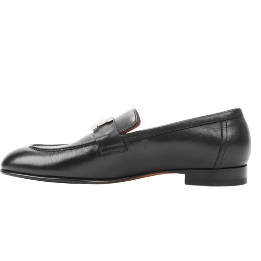 Hermès Paris Leather Loafers in black, size 38.5 EU, featuring smooth black leather, a classic loafer design, and silver-tone H buckle detail on the strap, displayed in profile against a white background.