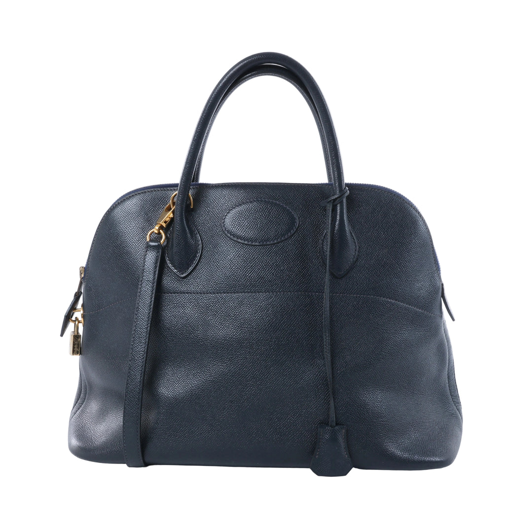 Hermès Bolide 35 dark Blue Indigo textured leather handbag with rounded top handles, gold-tone hardware, padlock and shoulder strap.
