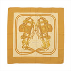 Hermès Carré 140 “Brides de Gala” silk scarf in brown tones with large central bridle and tack illustration on a cream ground and brown border.