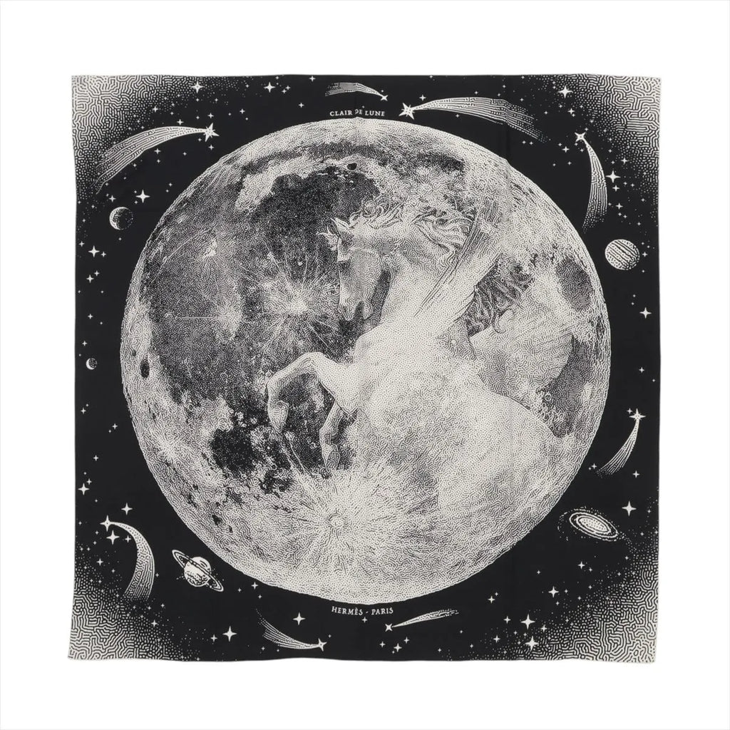 Hermès Carré 140 black cashmere-silk scarf with large moon illustration, stars, comets, and “Clair de Lune” text, laid flat