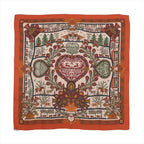 Orange Hermès Carré 140 cashmere-silk scarf laid flat with intricate multicolor folkloric motifs, floral and animal details, and a wide orange border on a white background.