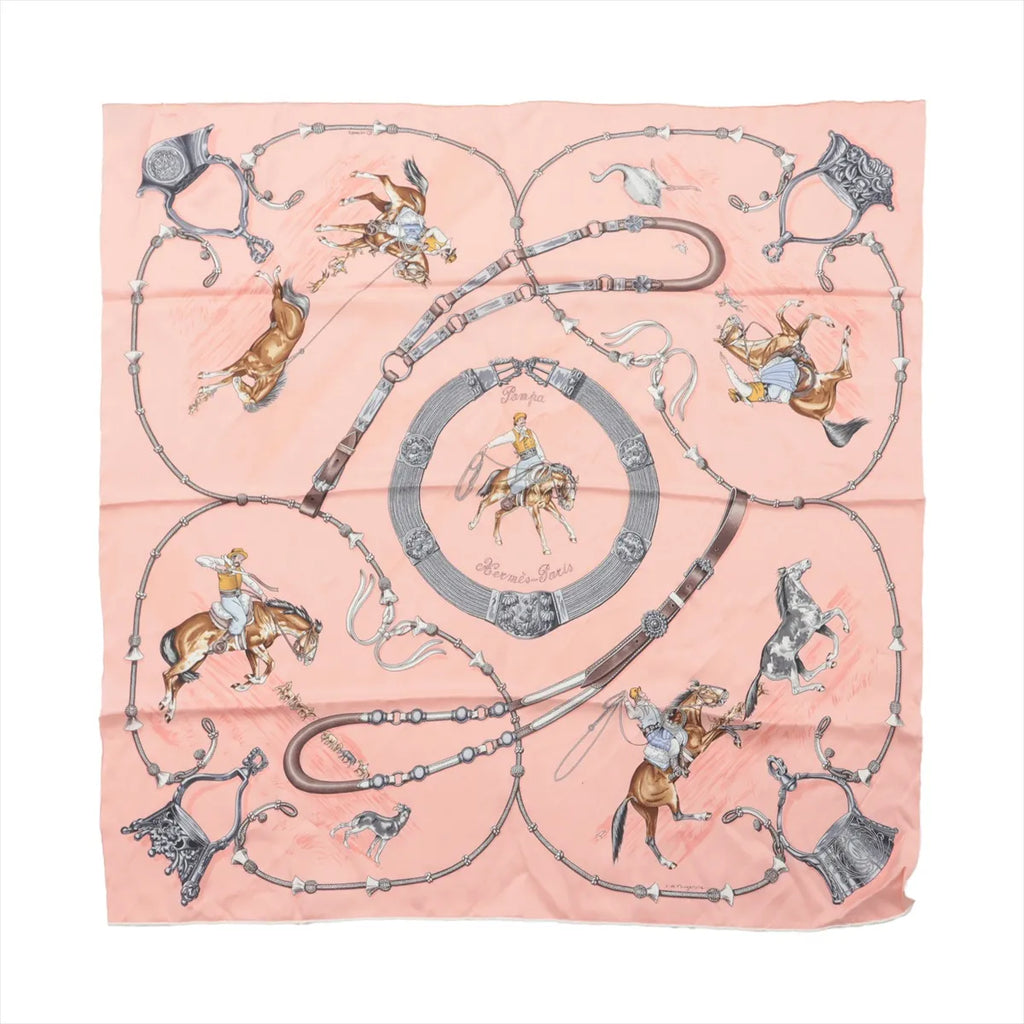 Hermès Carré 70 “Pampa Prairie” silk scarf in pink with equestrian rider and horse illustrations and looping rein and tack motif.