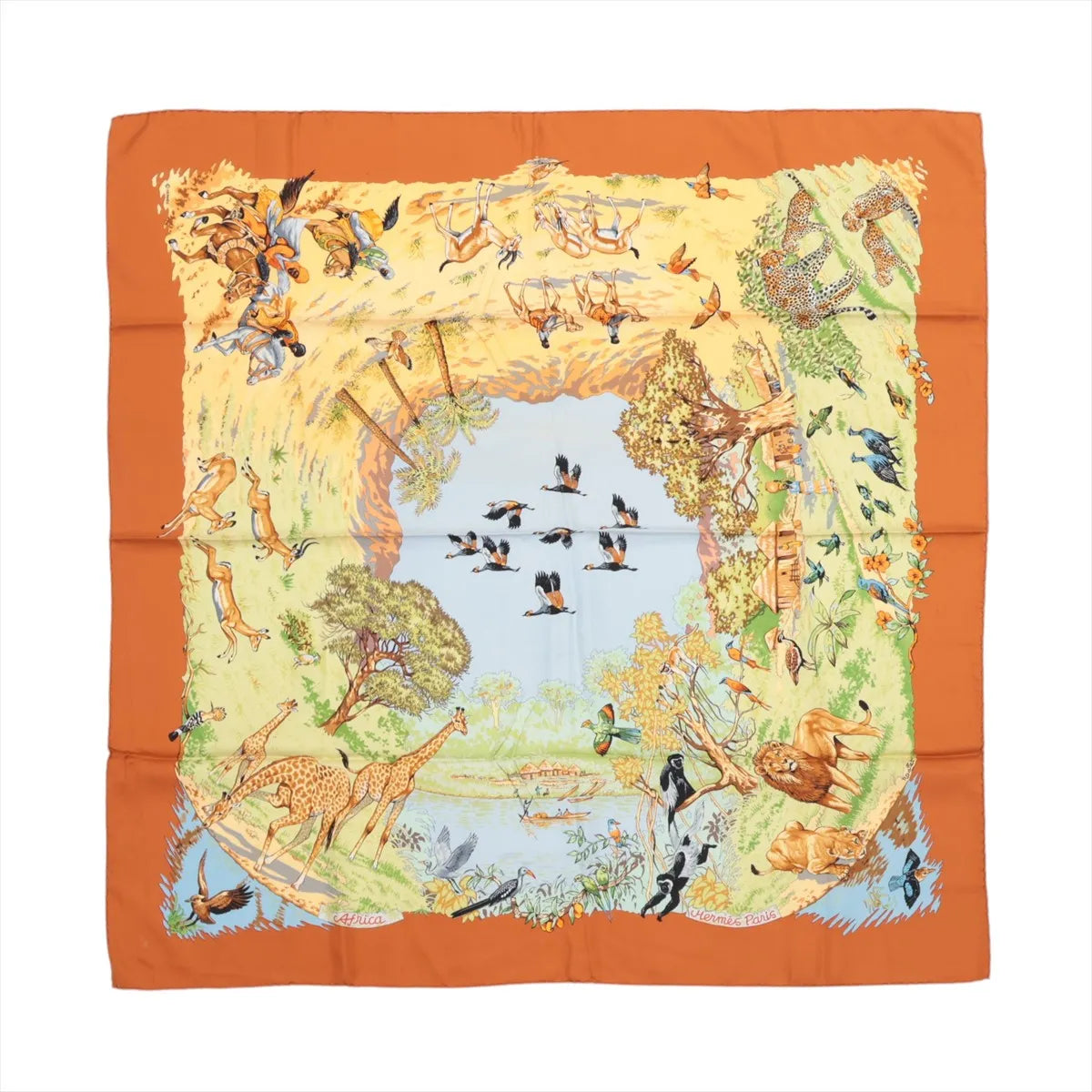 Hermès Carré 90 "Africa" silk scarf in brown featuring a central watering hole surrounded by a dynamic border of African wildlife, including giraffes, lions, birds, leopards, antelopes, and trees, all illustrated in earthy tones with an orange border.