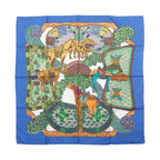 Hermès Carré 90 silk scarf in blue with multicolor horse and ornamental motif, white center, and blue border, laid flat