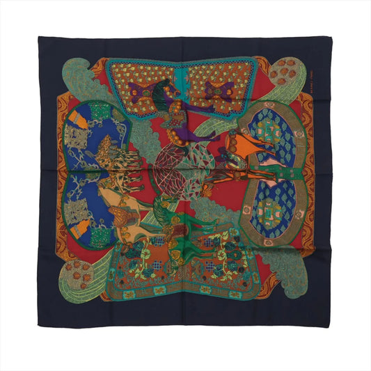 Hermès Carré 90 "Art des Steppes" silk scarf in navy blue, showcasing an elaborate central design of horsemen in traditional attire, surrounded by ornate patterns, vibrant textiles, and bold colors including red, green, orange, and blue.