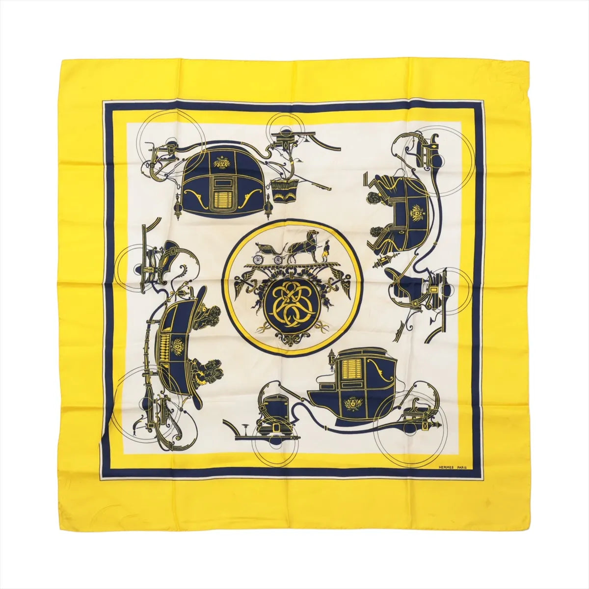 Hermès Carré 90 "Attelage en Arbalète" silk handkerchief in yellow, showcasing a symmetrical navy and gold carriage motif with a central medallion and bold yellow border.