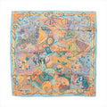 Hermès Carré 90 "Au Fil du Carré" silk handkerchief in multicolor, showcasing an intricate patchwork of illustrated motifs including threads, fans, florals, and weaving tools in bright hues, bordered with a golden rope design, laid flat against a white background.