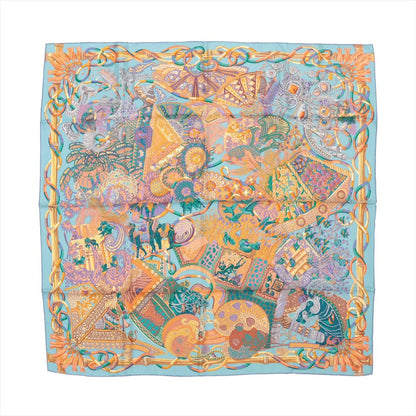 Hermès Carré 90 "Au Fil du Carré" silk handkerchief in multicolor, showcasing an intricate patchwork of illustrated motifs including threads, fans, florals, and weaving tools in bright hues, bordered with a golden rope design, laid flat against a white background.