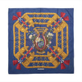 Hermès Carré 90 navy blue silk scarf with golden horse harness motifs, red tassels and a floral horseshoe design at the centre.
