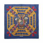 Hermès Carré 90 navy blue silk scarf with golden horse harness motifs, red tassels and a floral horseshoe design at the centre.