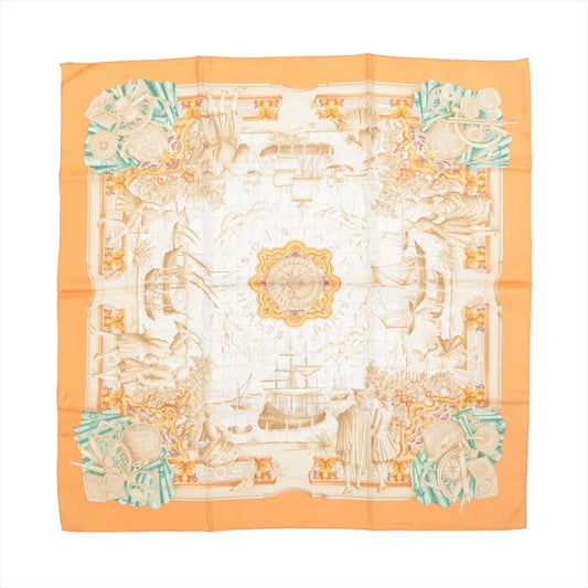 Hermès Carré 90 "Azulejos" silk scarf in orange, showcasing an ornate compass at the center surrounded by ships, explorers, and classical motifs in beige tones, with corner accents of globes and instruments in turquoise and coral.