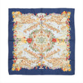 Hermès Carré 90 “Au Pays de Cocagne” silk scarf with navy border, central architectural landscape design, and multicolor floral and fruit border.