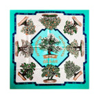 Hermès Bonsai square scarf laid flat, featuring potted flowering trees around a central bonsai, with turquoise panels, an ivory background and navy borders.