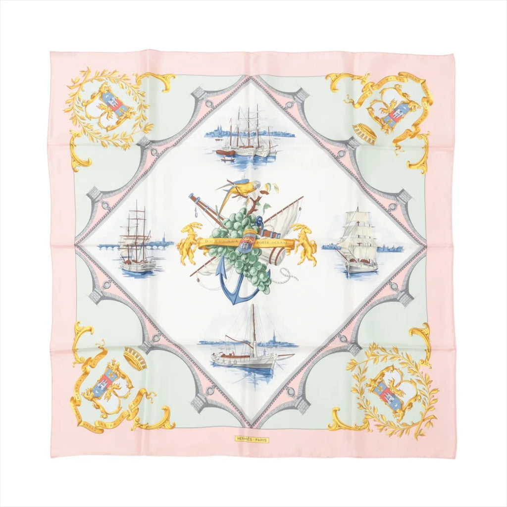 Hermès Carré 90 pink silk scarf with nautical sailing ships and central anchor motif, framed by mint green panels and gold crest details.