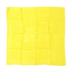 Yellow Hermès Carré 90 silk scarf laid flat with tonal jacquard pattern and subtle border, shown folded in a square grid on white background.