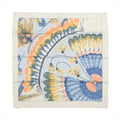 Hermès Carré 90 silk scarf in ivory and pale blue with large feather motifs in blue, yellow, and coral tones, framed by an ivory border.