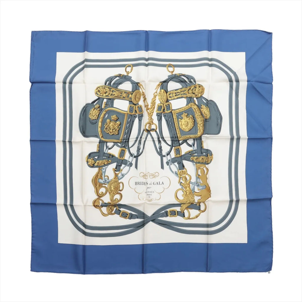Hermès Carré 90 silk scarf in blue and white with Brides de Gala equestrian harness artwork, gold-tone hardware details and blue border.
